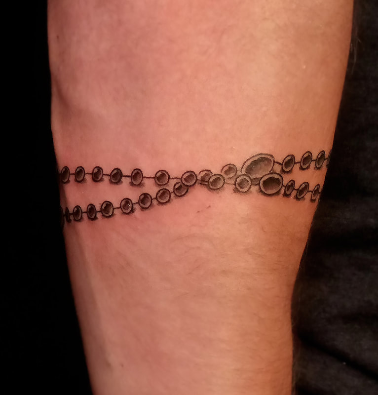 Rosary tattoo done by Brian Haggerty at Overlord Tattoo Studio, Palm Coast, Flagler Beach FL. 