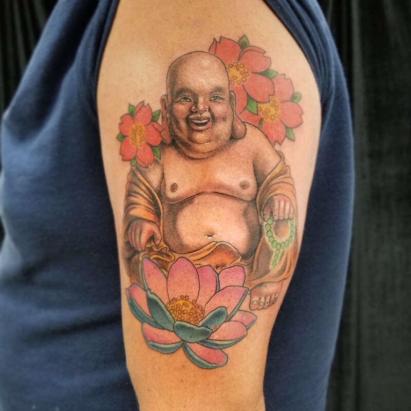 Buddha tattoo,cherry blossom tattoo,lotus flower tattoo, best tattoo shops in Palm Coast FL