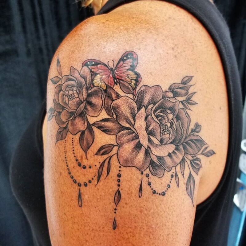 Butterfly roses tattoo done at Overlord Tattoo Shop in Palm Coast FL